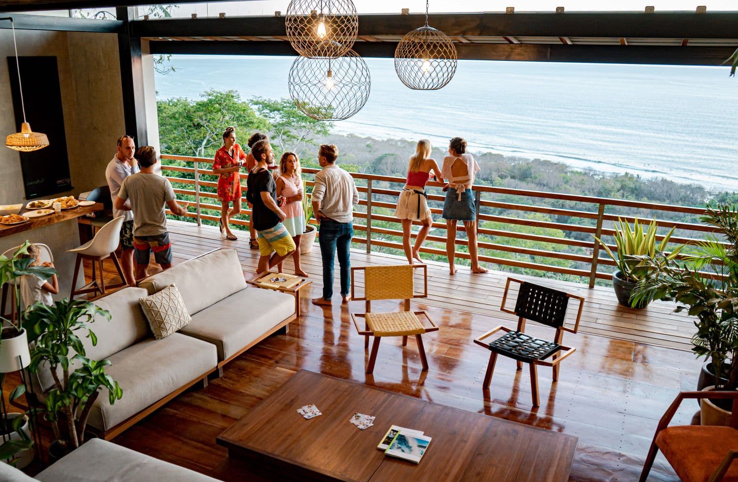 People gathered on a deck above the ocean